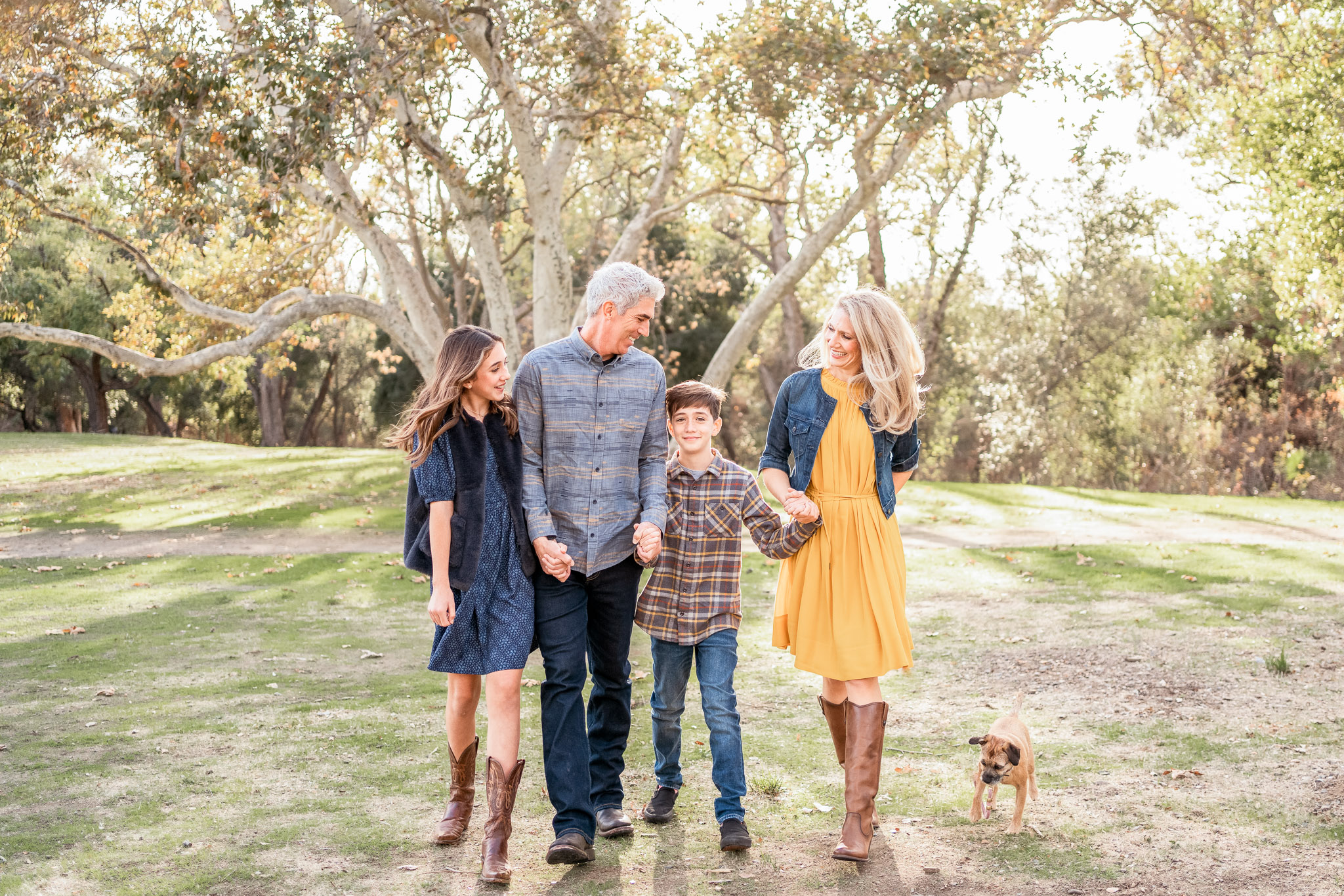 san jose family photography session with a family of four and their dog walking in a park